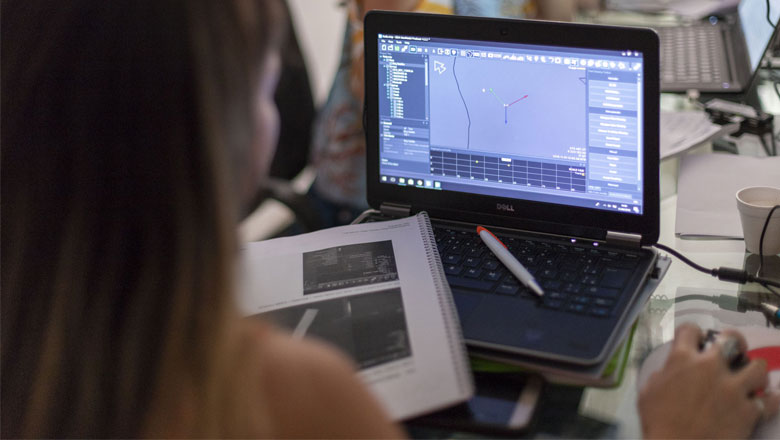 A female student learning how to use NaviSuite software in the classroom with a computer