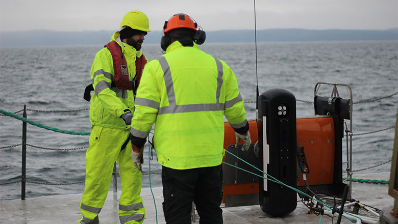 Two crew members getting the ScanFish ROTV ready to be deployed into the sea