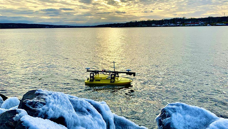 The EchoBoat™ USV performing a bathymetric survey of a lake while being supervised from shore